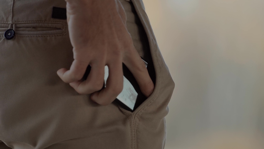 Man Takes Mobile Phone From His Trousers Pocket. Man Hand Put Mobile Phone In Back Pocket. Male Take Ringing Phone From Pocket And Calling. Business Guy Pulls His Smartphone And  Looks At Screen Call Royalty-Free Stock Footage #1040633921