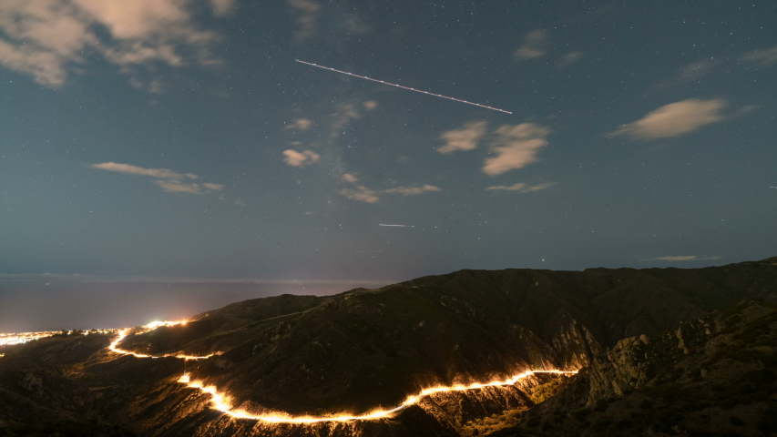 Astro timelapse of Milky Way galaxy over highway in Malibu, California
