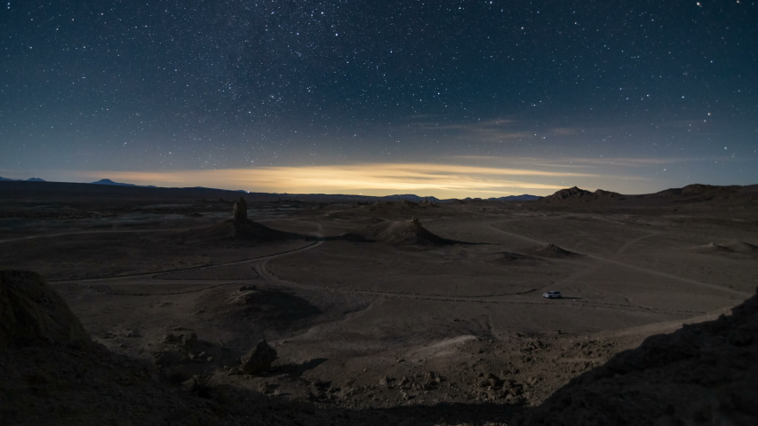 Astro timelapse of starry sky over expansive desert landscape at Trona Pinnacles in Mojave Desert, California