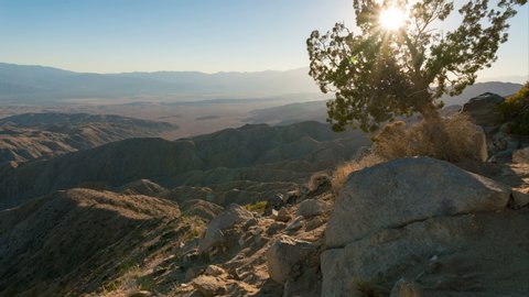 Timelapse pan/tilt shot of day to night transition over badlands of Coachella Valley in California