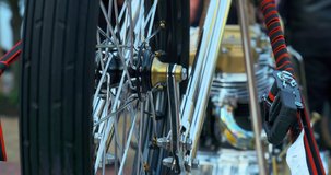 Yellow Custom Motorcycle with chrome wheels, close up.  Metal lines, close up, day clip in 4k