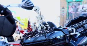 Custom Touring motorcycle with black rear fender and white skull and american flag.  Metal lines, close up, day clip in 4k