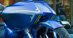 Custom Motorcycle with chrome wheels, brake disc and blue front fender.  Metal lines, close up, day clip in 4k