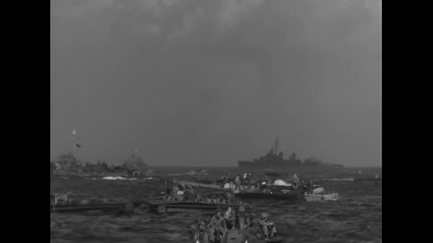 CIRCA 1944 - LVTs approach the foggy beach during the Invasion of Guam in WWII.