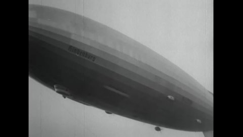 CIRCA 1937 - The Hindenburg flies above Lakehurst, New Jersey and suddenly bursts into flame.