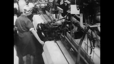 CIRCA 1950 - Women working as weavers in a textile mill are given new equipment to make their looms more productive.