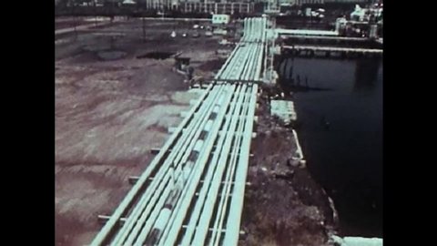 CIRCA 1975 documentary explores 1970s oil crisis energy systems with clips of oil rigs, coal manufacturing, pipe lines, and gas lines.