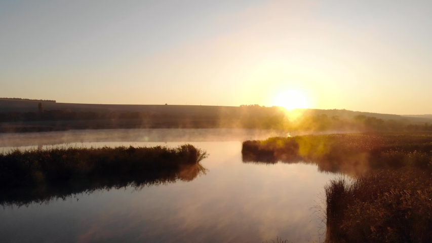 Flying over a Lake with a Fog Above Water. Morning Mist Haze Drone Mist Fog Over Lake. Aerial Mist In Autumn. Autumn Colors Of Europe. Cold Morning Pond. Haze Over Lake in Countryside
