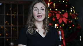 woman talking with the background of a Christmas tree  