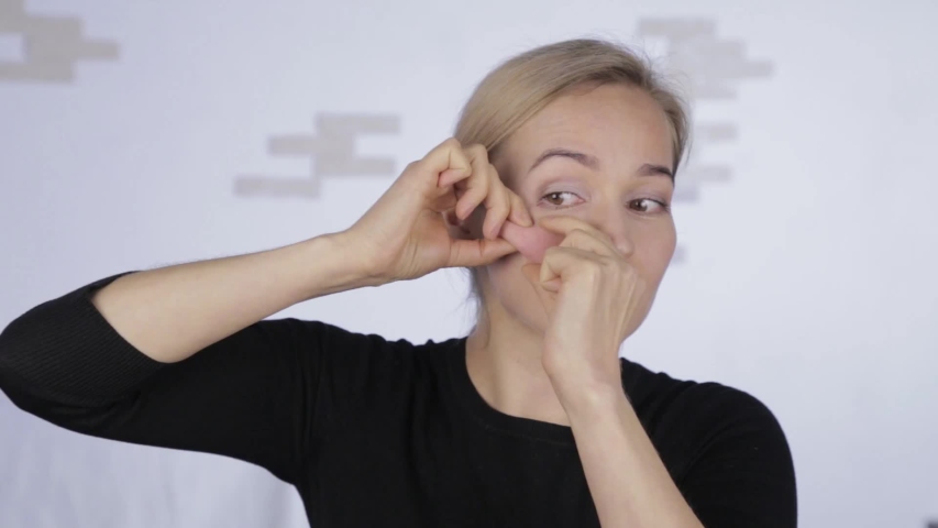 prevention of skin aging, woman doing sculptural massage on your face. woman doing facial massage after a hard day work