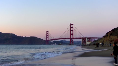 Unidentified people at Baker Beach in San Francisco, California, the Golden Gate bridge in the background, 2018
