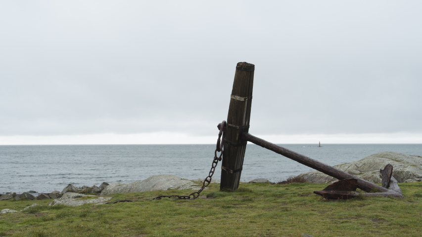 A static shot of a big anchor lying next to the ocean on the west coast of Sweden, outside of Varberg.
