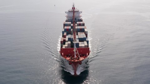 Container Ship. roaring across the Sea, Aerial view.
