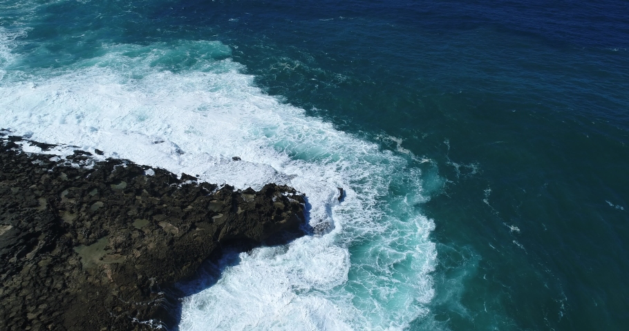 Large waves crash against sharp rocks on the Puerto Rican coastline at Punta Morrillos in Arecibo.