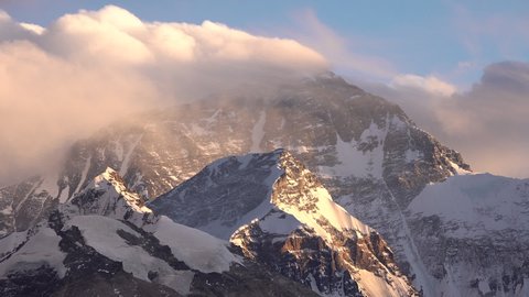 Beautiful time lapse of colorful sunset over summit of Mount Everest (seen from the Chinese side), iconic mountain peak in Himalayan ranges, natural beauty on Tibet (China) Nepal border