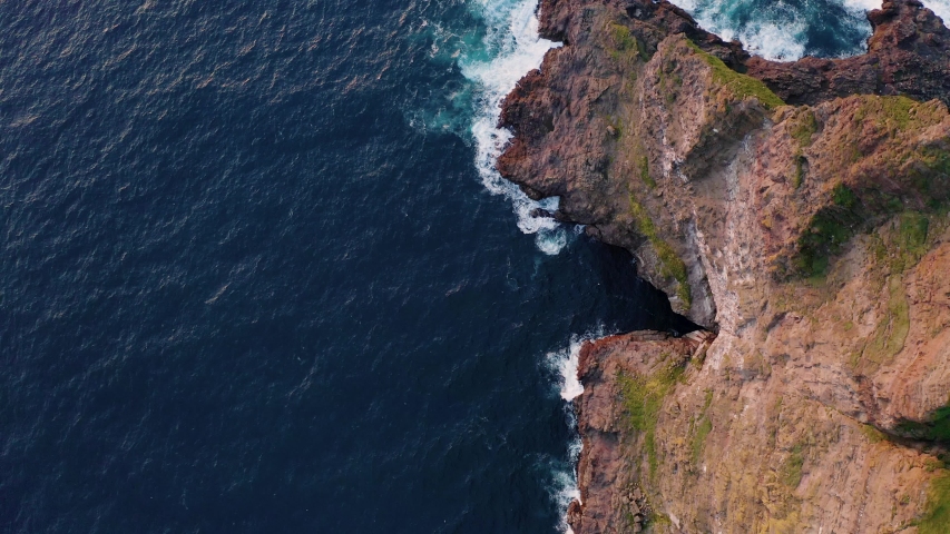 Aerial drone video flying over Faroe islands coastline, glowing by sunset light. Kalsoy island, Faroe islands, Denmark. UHD 4k video