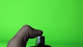 Hand holding Lighter with Sparkles and Fire on green screen background