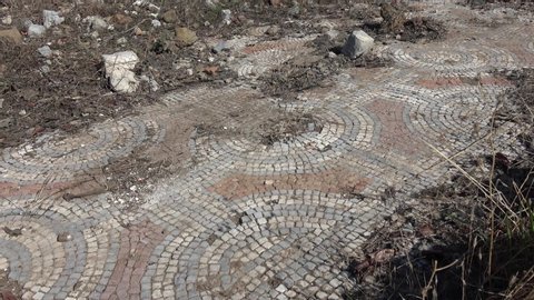 Knight island, Fethiye, Turkey - 30th of October 2019: 4K Viewing remains of ancient mosaic littered and covered by stones
