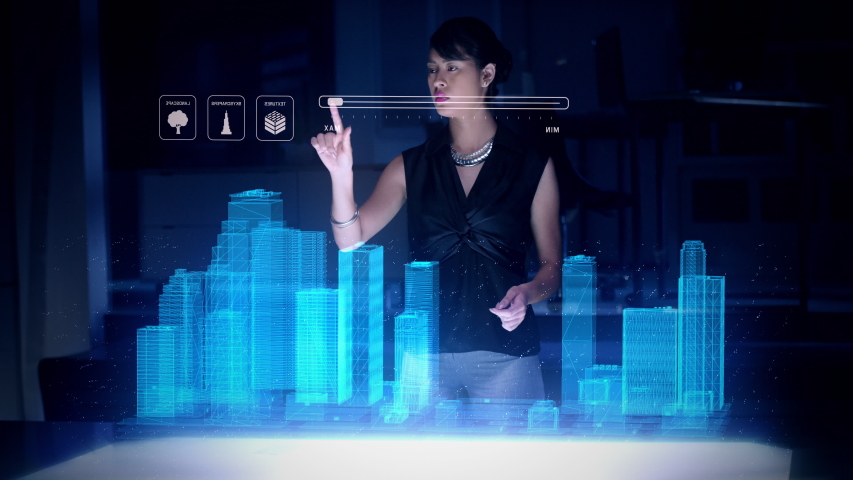 Female Architect works with Holographic Augmented Reality 3D City Model using gestures showing graphs. Technologically Advanced Office with Augmented Virtual Modeling Software on Futuristic Display. - Powered by Shutterstock - Get 15% off with code: PIKWIZARD15