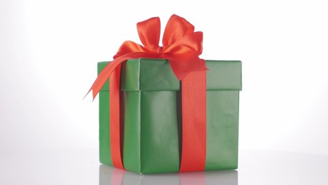 green gift box with a red bow. Rotation