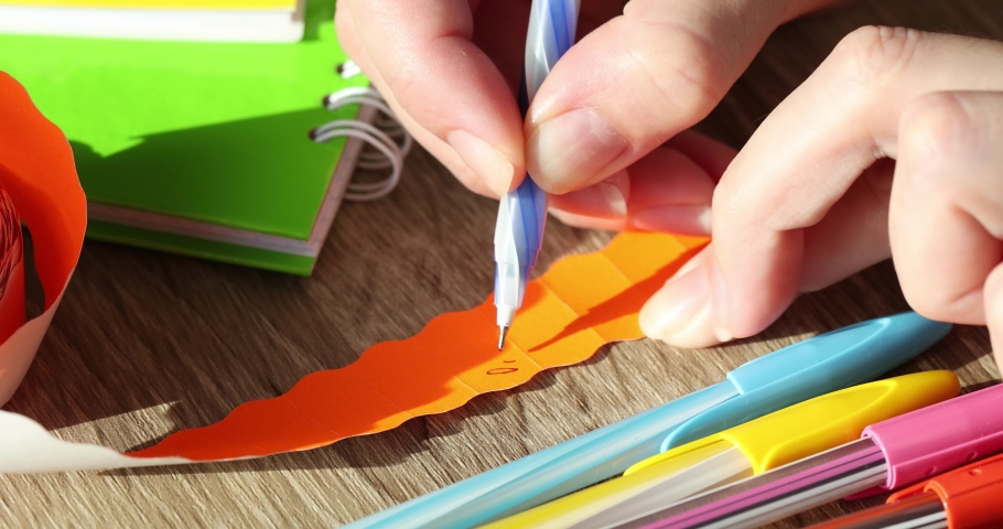 A female seller writes a price tag on a product price of 0.99 cents