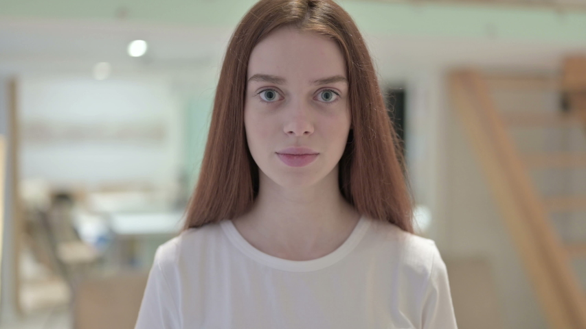 Portrait of Angry Redhead Young Woman Shouting 