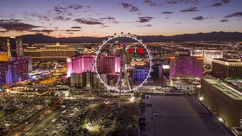 Las Vegas, Nevada/USA - November 6th, 2019: The High Roller observation wheel spins with color as the greater Las Vegas Valley undergoes its own color transformation from daylight to dusk.