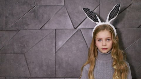Little girl with hare ears, Having such a long ears. Easter bunny concept. Little girl wearing bunny ears. Small girl in bunny headband for Easter celebration. Easter bunny is symbol of Easter.