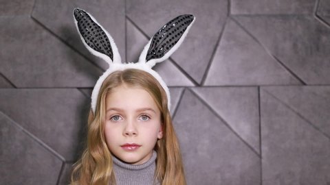 Little girl with hare ears, Having such a long ears. Easter bunny concept. Little girl wearing bunny ears. Small girl in bunny headband for Easter celebration. Easter bunny is symbol of Easter.