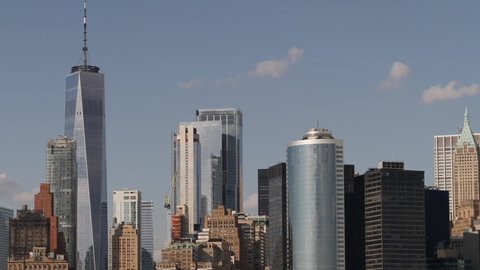 NYC's Lower Manhattan Skyscrapers panning under Summer Partly Cloudy Skies
