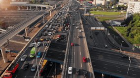 Beautiful aerial panorama of busy traffic on multi-level highway in Moscow. Camera moving along the road showing the cars driving in a big city on the sunny evening.