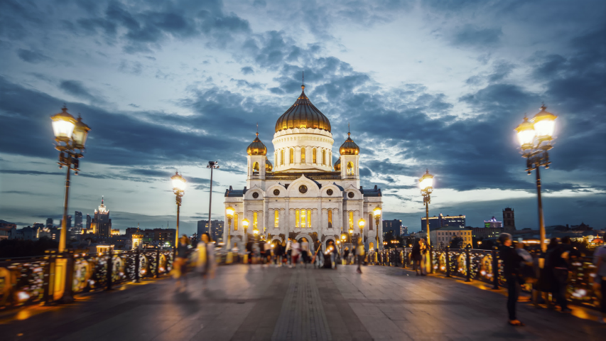 Amazing hyperlapse of the Cathedral of Christ the Saviour in Moscow on the evening. Camera moving along the beautiful bridge towards the church all in glittering lights, night city on the background. Royalty-Free Stock Footage #1040741054