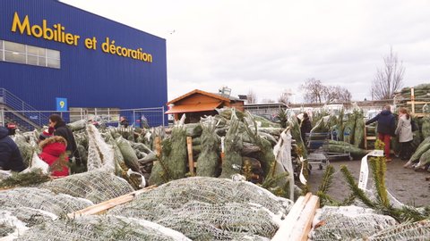 Paris, France - Circa 2018: large IKEA parking arranged as an area of sale point of Swedish fir trees for the upcoming Christmas winter holidays