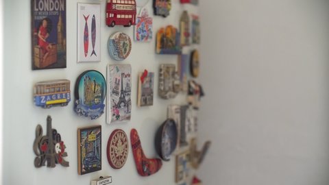 Bucharest / Romania - 02 21 2019: Souvenir magnets from different places from around the world on a fridge at home. Travel destinations