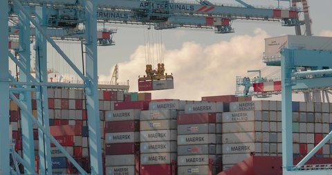 ROTTERDAM, THE NETHERLANDS - SEPTEMBER 18, 2019: Containers loaded onto a huge cargo ship in the APM Terminals Rotterdam, busiest port of Europe. Maersk Line Triple E class ship.
