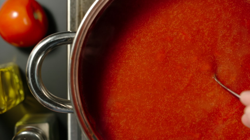 TOP VIEW: Stirring Rich Tomato Sauce While Cooking In A Steel Saucepan | Shutterstock HD Video #1040750312