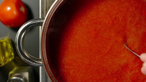 TOP VIEW: Stirring Rich Tomato Sauce While Cooking In A Steel Saucepan