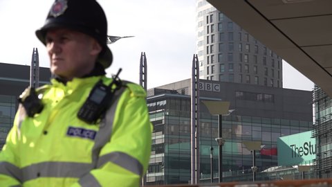 Salford / United Kingdom (UK) - 02 23 2019: A police officer stands guard in front of BBC Media city UK Salford offices