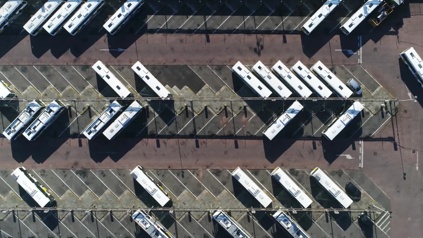 Aerial top down view of electric powered coach terminus is designated place where coaches are charged and start scheduled route termini can be located at stations interchanges garages or stops 4k Royalty-Free Stock Footage #1040786126