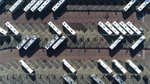 Aerial top down view of electric powered coach terminus is designated place where coaches are charged and start scheduled route termini can be located at stations interchanges garages or stops 4k