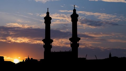 Minarets in Great Mosque of Mecca, Time Lapse at Sunrise with Colorful Clouds and Dark Silhouette, Saudi Arabia