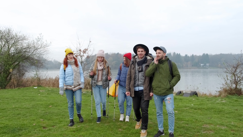 Group of hikers walking on a mountain at autumn day