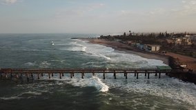 4K aerial drone video of Namibian Atlantic coastline, Swakopmund vintage buildings, town panorama, beach, old Jetty pier, landscape with ocean background of holiday resort at Namibia's west coast