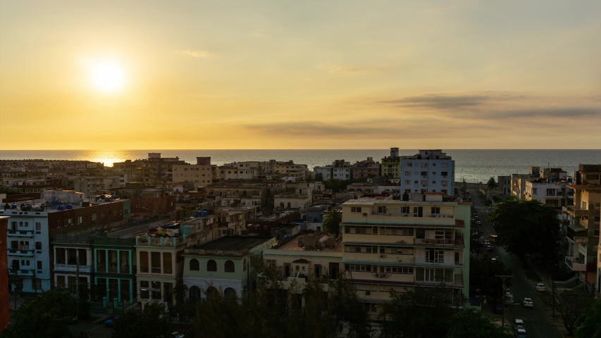 Aerial Time lapse view of the residential neighborhood in the Havana City, Capital of Cuba, during a colorful and cloudy sunset.