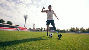 Disabled man with a bionic leg is playing football - Powered by Shutterstock - Get 15% off with code: PIKWIZARD15