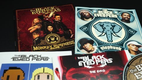 Rome, Italy - November 02, 2019: CD and artwork of CD and artwork of alternative American hip hop band The Black Eyed Peas. By 2010 they had sold 35 million albums and 41 million singles