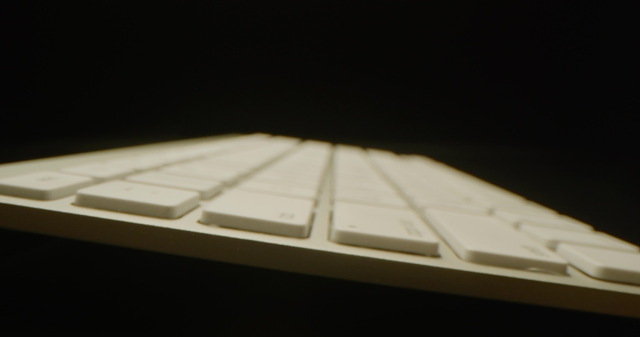 White keyboard macro shot, dramatic look, red epic, slow motion, black background, 