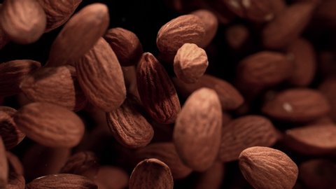 Super Slow Motion Shot of Almonds Flies After Being Exploded against Black Background, 1000fps.