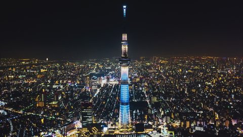 Tokyo, Japan - Oct 31, 2019: Hyperlapse time-lapse aerial view of Tokyo Skytree and Japan cityscape at night. Japan tourism landmark, Asia travel destination, or modern building architecture concept