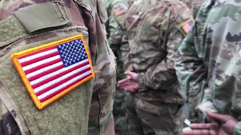 US soldiers. US army. USA patch flag on the US military uniform. Soldiers on the parade ground from the back. Veterans Day. Memorial Day.
